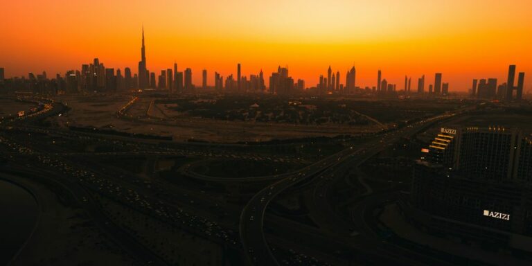 an aerial view of a city at sunset