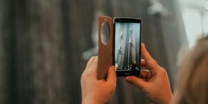 a woman taking a picture with her cell phone