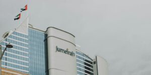 a tall building with a flag on top of it