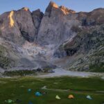 a group of tents set up in the mountains