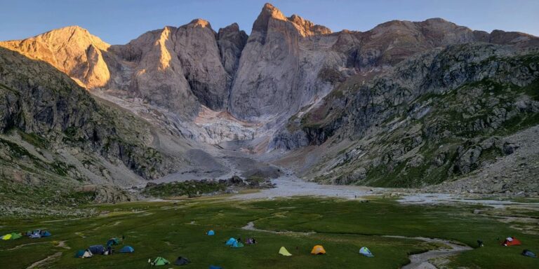 a group of tents set up in the mountains