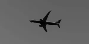 a large jetliner flying through a gray sky