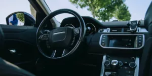 the interior of a car with a steering wheel and dashboard