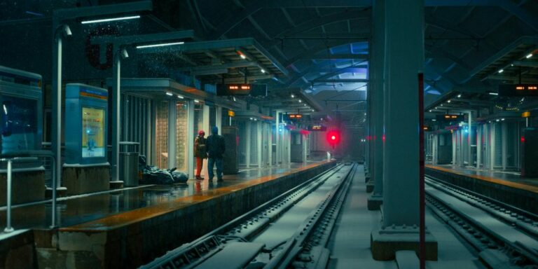 a train station with tracks covered in snow