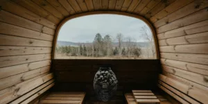 a wooden room with a large window and a bench