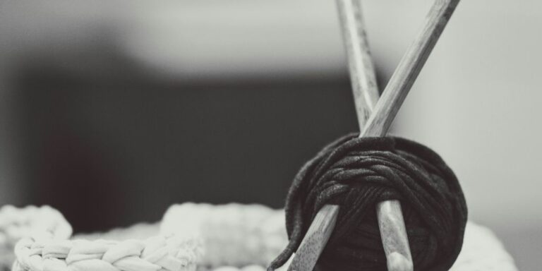 gray wooden sticks with black yarn