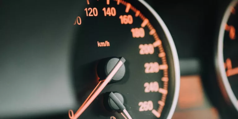 closeup photo of black analog speedometer