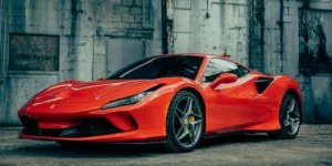 red ferrari 458 italia parked near gray building