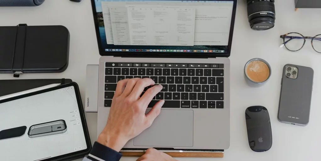 a man sitting at a desk working on a laptop