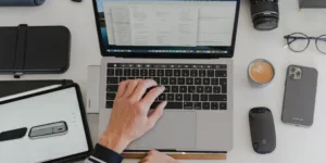 a man sitting at a desk working on a laptop