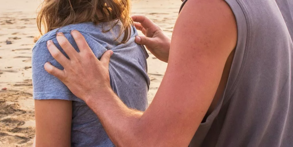 man massaging woman at the back