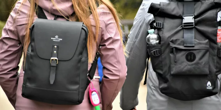 woman in black leather jacket carrying black leather backpack