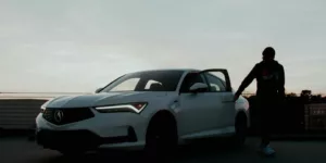 a man standing next to a white car