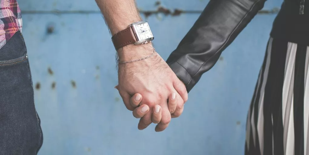 man and woman holding hands