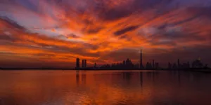 view of body of water near city during sunset