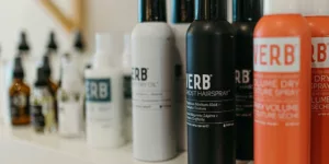 a white shelf topped with lots of different types of hair products