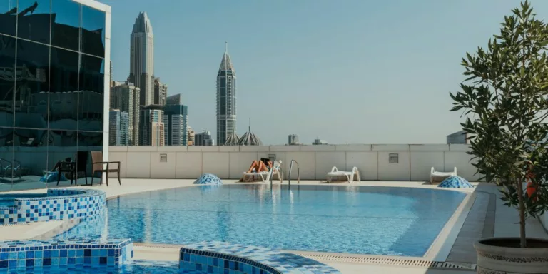 A large swimming pool with a view of a city