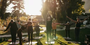 a group of people doing yoga in a park