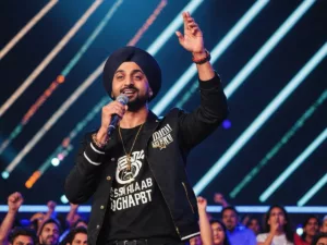 Diljit Dosanjh performing on stage with vibrant lights