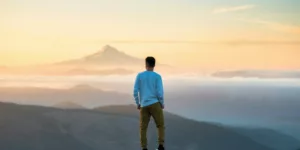 man standing on top of mountain