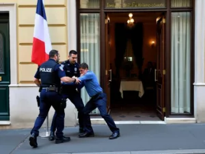 Police detaining intruder outside Iranian Consulate in Paris