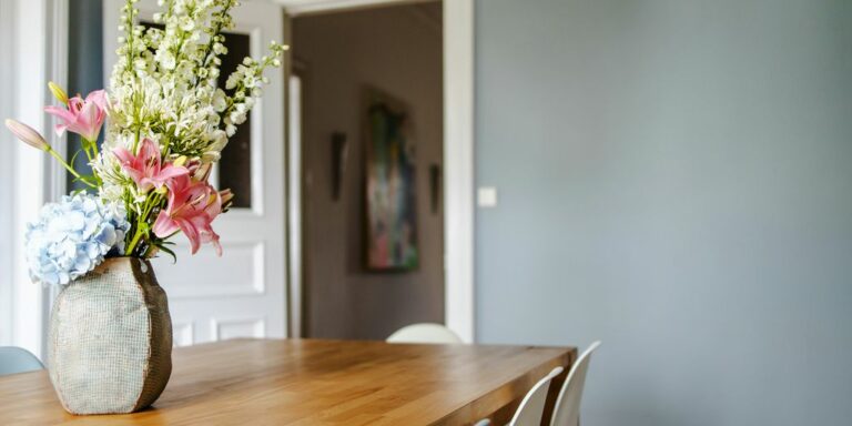 white and pink flower bouquet on brown wooden table