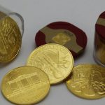 gold round coins on white surface
