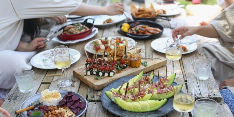 group of people eating on backyard
