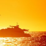 A boat is in the water at sunset
