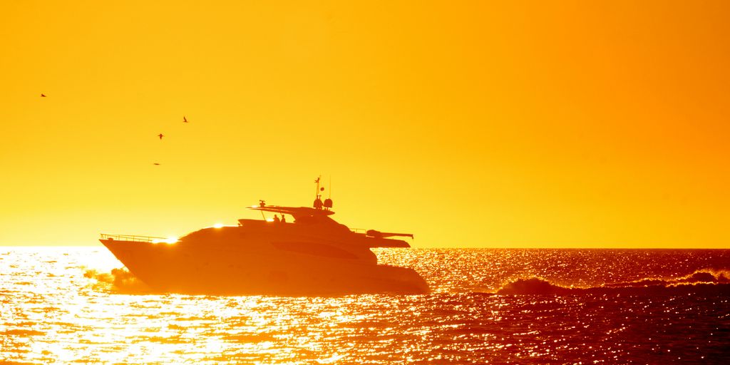 A boat is in the water at sunset
