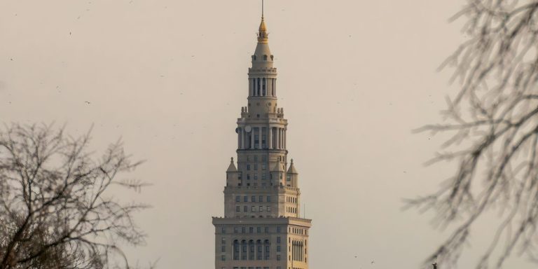 A very tall building with a clock on it's side