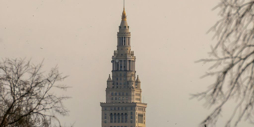 A very tall building with a clock on it's side