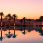Luxury resort pool, UAE desert at sunset