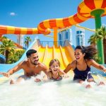 Family enjoying Dubai's Atlantis waterpark slides.