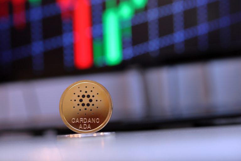 Ada,Cardano,Coin,Sitting,On,A,Desk,With,A,Red