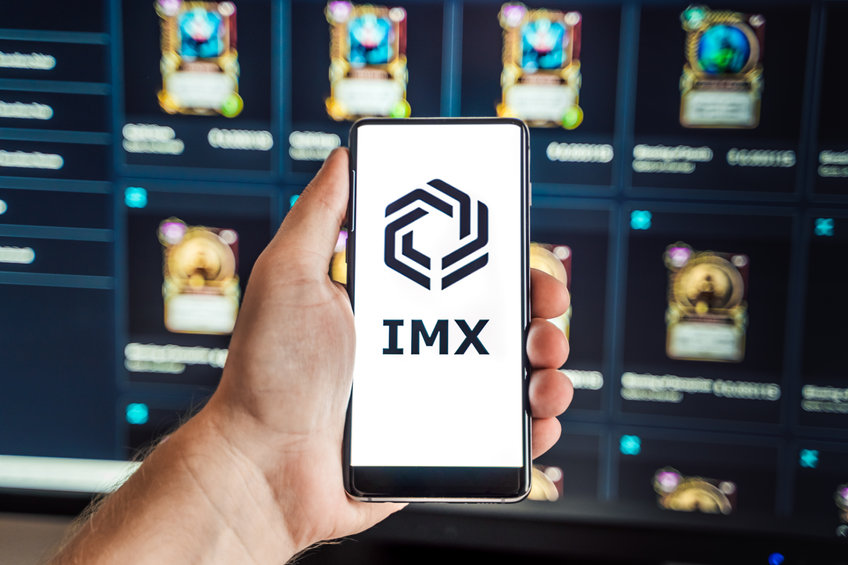 Russia Moscow 04.09.2021.Logo,screenshot of Immutable X, IMX token.Blockchain nft ethereum cryptocurrency game in laptop,mobile phone.Man playing with crypto coins.Earning digital money.Land,heroes
