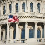 American flag flies by the Capitol building in Washington DC USA