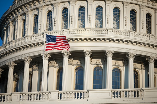 American flag flies by the Capitol building in Washington DC USA
